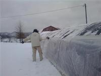 Breaking_ice_off_greenhouse_13010